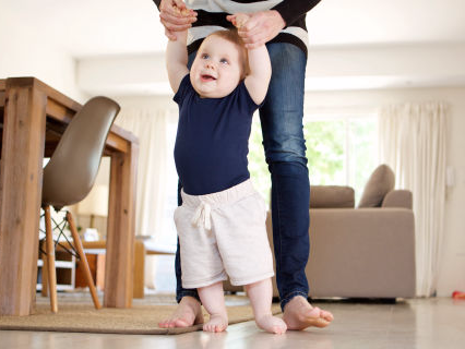 Baby boy taking first steps